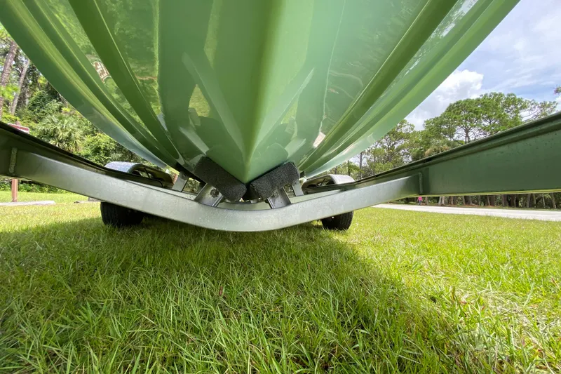 Slide: The Image of 2023 Key West 239 FS boat on trailer, grassy background, low-angle view. - 10