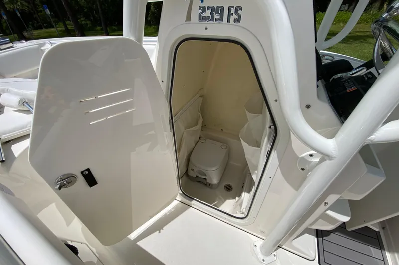 Slide: The Image of 2023 Key West 239 FS boat with open cabin door revealing interior amenities. - 101