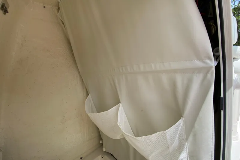 Slide: The Image of 2023 Key West 239 FS boat interior with white upholstery and storage pockets. - 104