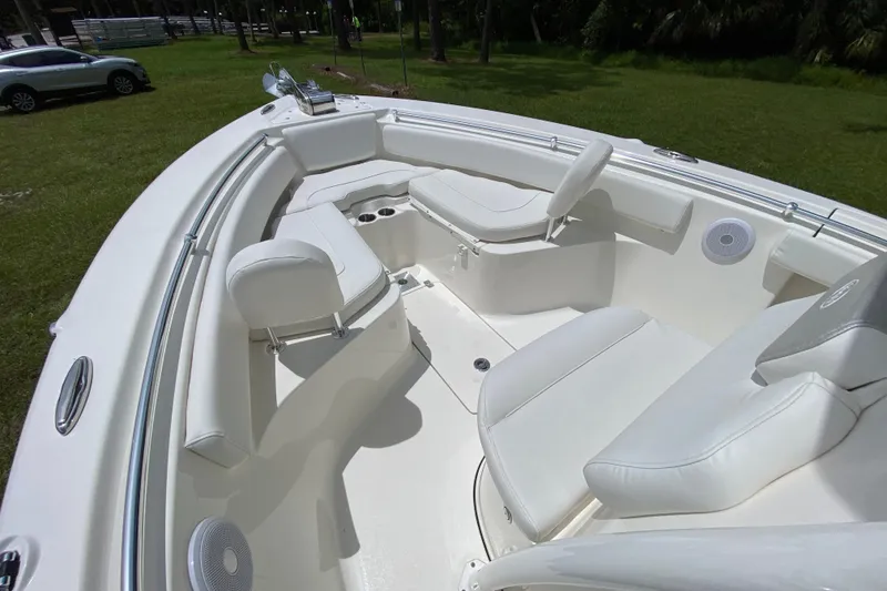 Slide: The Image of 2023 Key West 239 FS boat interior with white seating and cup holders. - 106