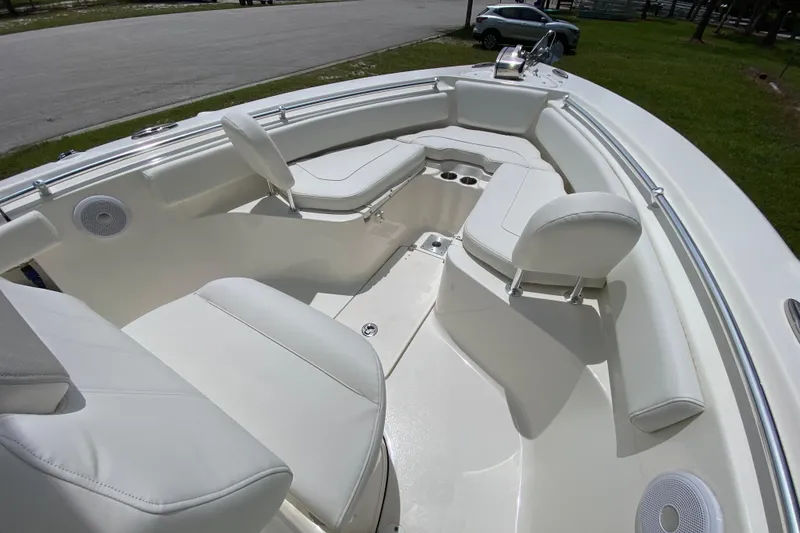Slide: The Image of 2023 Key West 239 FS boat interior with white seating and cup holders. - 107