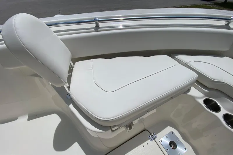 Slide: The Image of 2023 Key West 239 FS boat with white cushioned seating and stainless steel cup holders. - 108