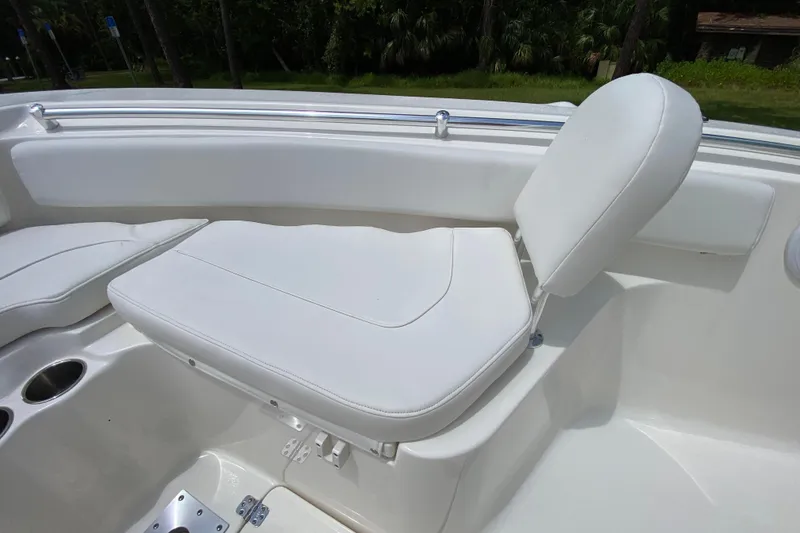 Slide: The Image of 2023 Key West 239 FS boat interior with white cushioned seating and cup holders. - 109
