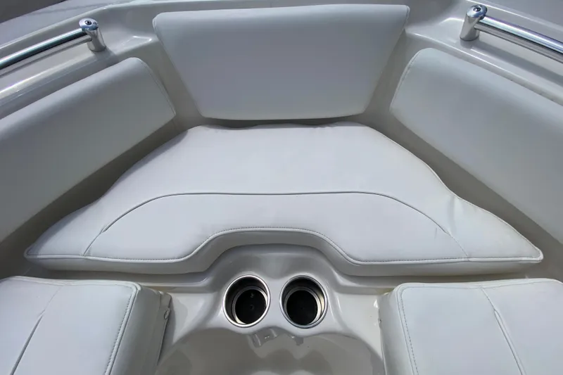 Slide: The Image of 2023 Key West 239 FS boat interior with white cushioned seating and dual cup holders. - 110