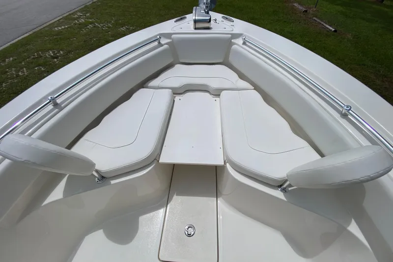 Slide: The Image of 2023 Key West 239 FS boat interior with white cushioned seating and stainless steel rails. - 113