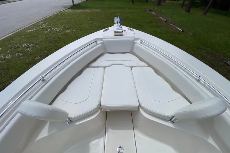 Slide: The Image of 2023 Key West 239 FS boat interior with white cushioned seating and stainless steel railings. - 114
