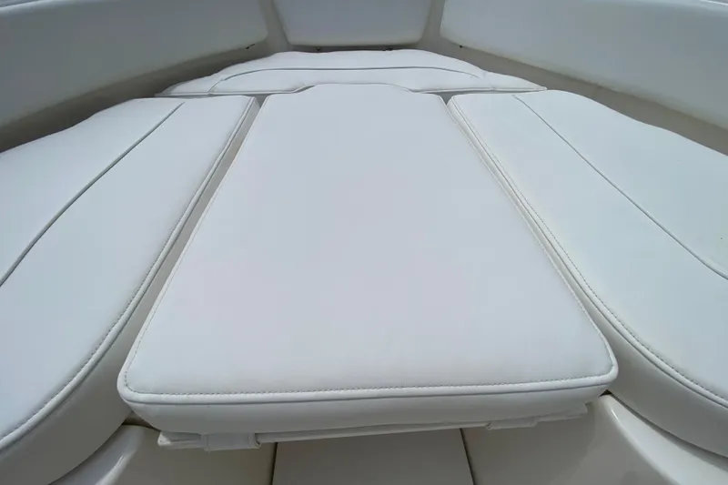 Slide: The Image of 2023 Key West 239 FS boat with white cushioned seating area. - 115