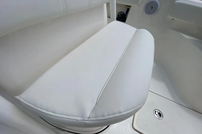 Slide: The Image of 2023 Key West 239 FS boat seat with white upholstery and speaker detail. - 116
