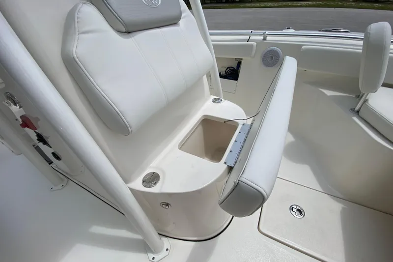 Slide: The Image of 2023 Key West 239 FS boat interior with cushioned seating and storage compartment. - 117