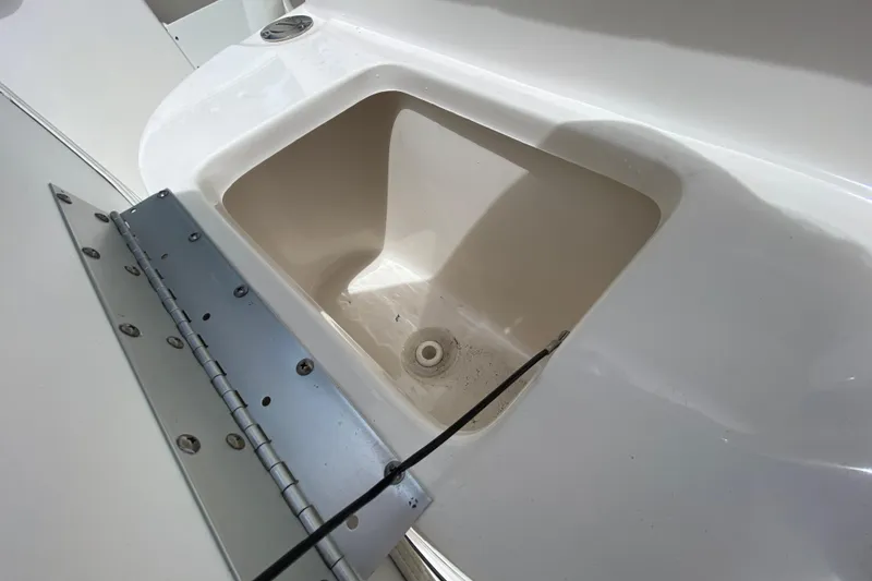 Slide: The Image of 2023 Key West 239 FS boat storage compartment with open lid. - 118