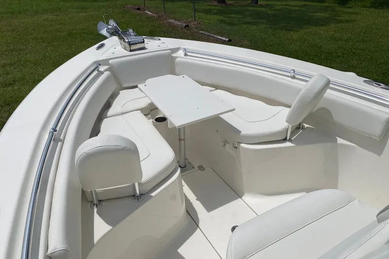 Slide: The Image of 2023 Key West 239 FS boat interior with white seating and table setup. - 119