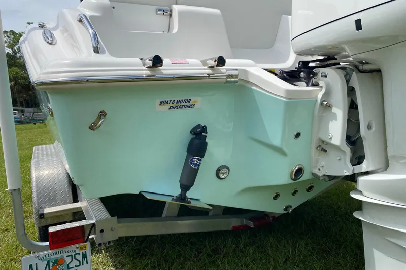 Slide: The Image of 2023 Key West 239 FS boat rear view with motor and trailer. - 12