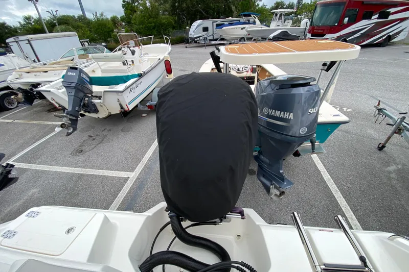 Slide: The Image of 2023 Key West 239 FS boat with Yamaha 90 outboard motor in parking lot. - 121