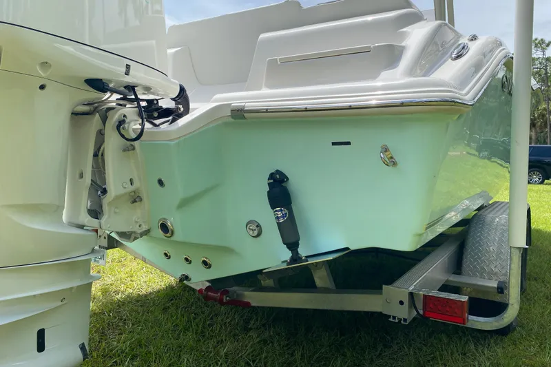 Slide: The Image of 2023 Key West 239 FS boat on trailer, rear view, showcasing engine and hull details. - 13