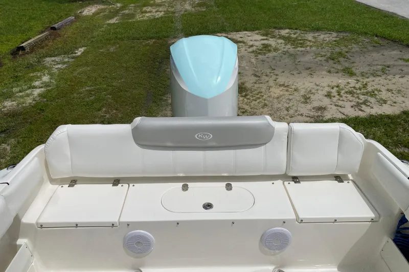 Slide: The Image of 2023 Key West 239 FS boat interior with white seating and storage compartments. - 16