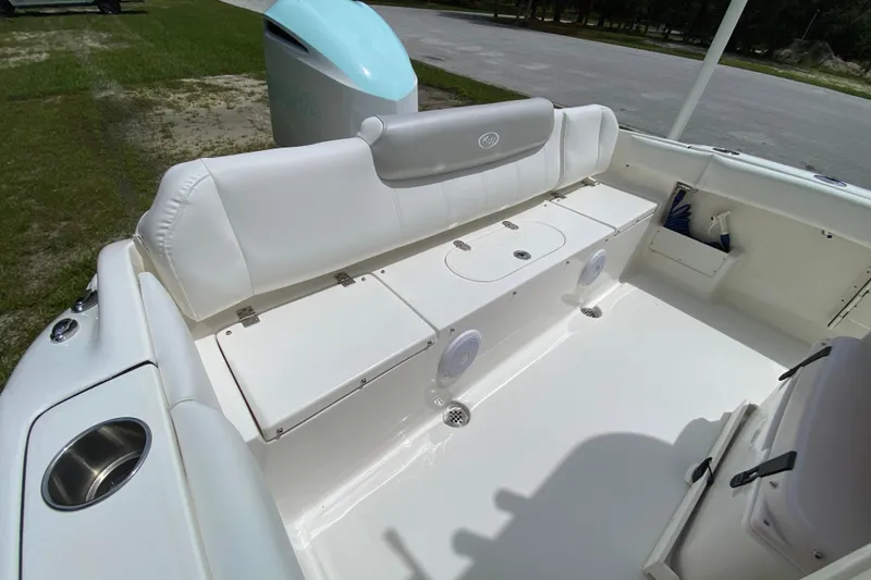 Slide: The Image of 2023 Key West 239 FS boat interior with white seating and storage compartments. - 17
