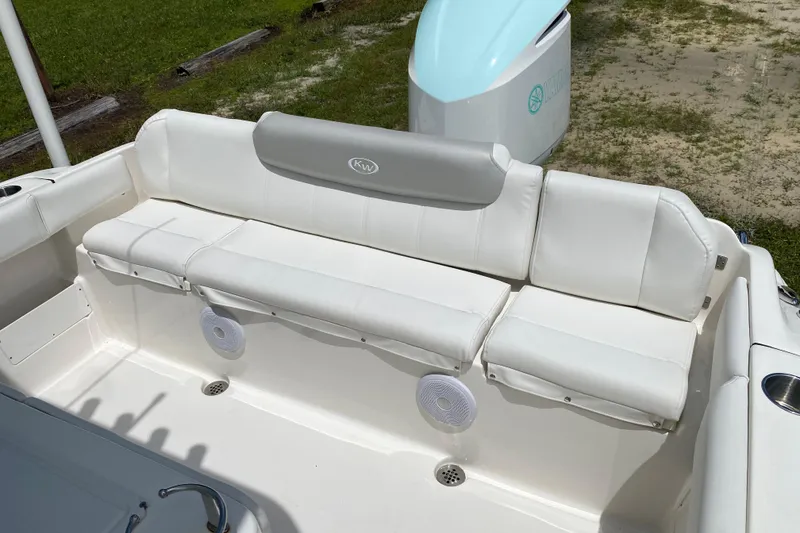 Slide: The Image of 2023 Key West 239 FS boat with white cushioned seating and speaker. - 18