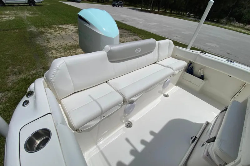 Slide: The Image of 2023 Key West 239 FS boat interior with white seating and cup holders. - 19