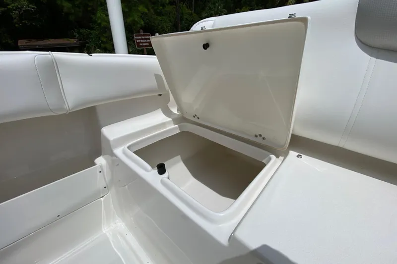 Slide: The Image of 2023 Key West 239 FS boat storage compartment with open lid. - 24