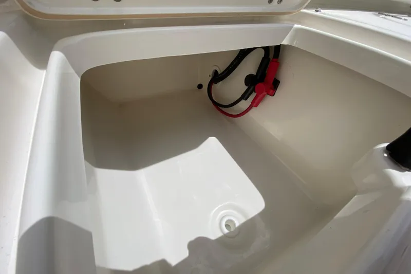 Slide: The Image of 2023 Key West 239 FS boat storage compartment with wiring and drainage. - 25