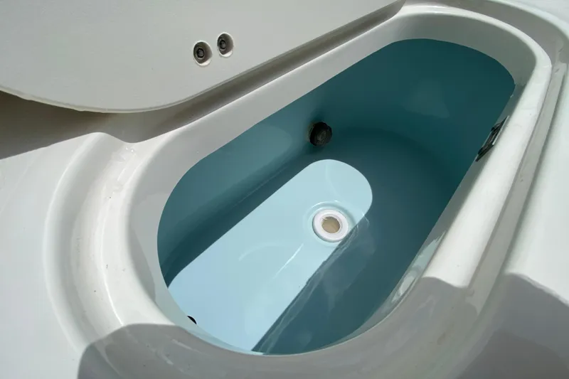 Slide: The Image of Livewell compartment on 2023 Key West 239 FS boat, featuring a clean, white interior. - 28