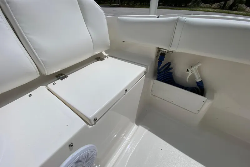 Slide: The Image of 2023 Key West 239 FS boat interior with white seating and storage compartment. - 29