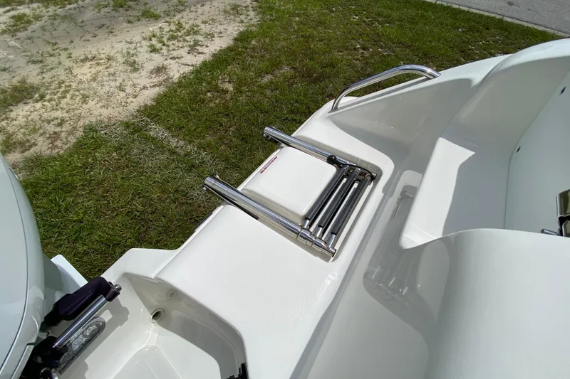 Slide: The Image of 2023 Key West 239 FS boat with stainless steel swim ladder on grass. - 33