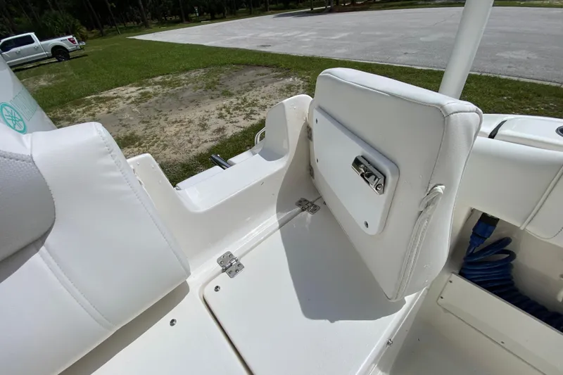 Slide: The Image of 2023 Key West 239 FS boat interior with white seating and storage compartment. - 34