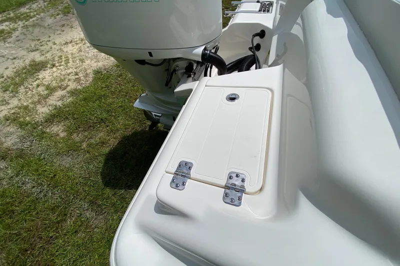 Slide: The Image of 2023 Key West 239 FS boat with Yamaha engine, featuring a rear storage compartment. - 36