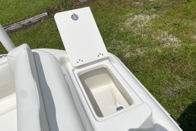 Slide: The Image of 2023 Key West 239 FS boat storage compartment with open lid, showcasing interior space. - 37
