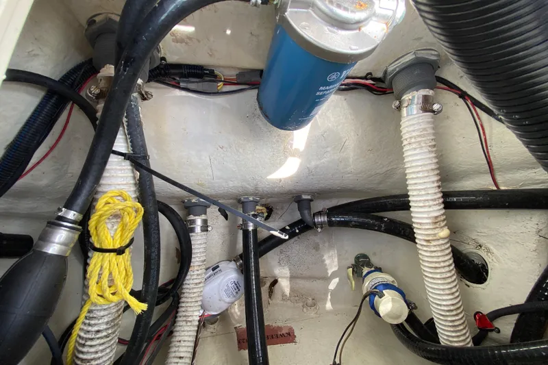 Slide: The Image of 2023 Key West 239 FS boat interior showing hoses, wiring, and components. - 41