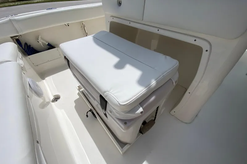 Slide: The Image of 2023 Key West 239 FS boat interior with cushioned seating and storage compartment. - 44