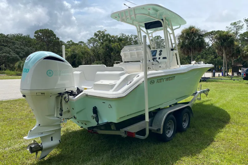 Slide: The Image of 2023 Key West 239 FS boat on trailer with Yamaha engine, parked on grass. - 5