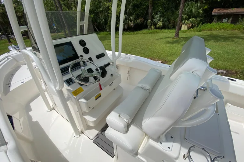 Slide: The Image of 2023 Key West 239 FS boat interior with steering console and seating. - 55