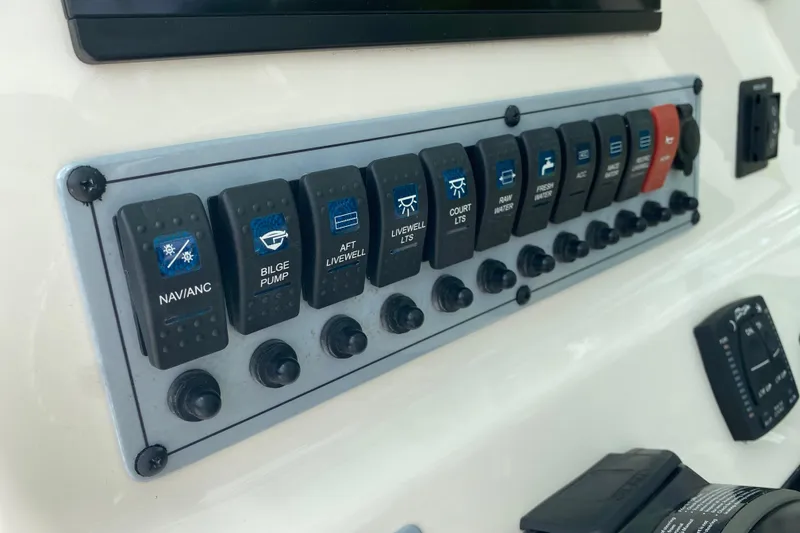 Slide: The Image of Control panel of 2023 Key West 239 FS boat with labeled switches. - 63