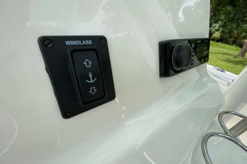 Slide: The Image of 2023 Key West 239 FS boat windlass control and audio system panel. - 66