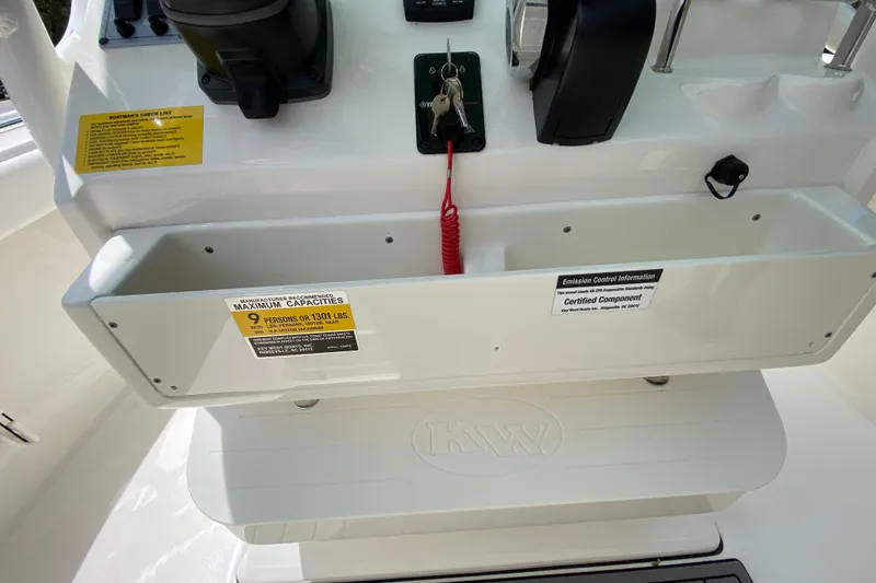 Slide: The Image of 2023 Key West 239 FS boat console with capacity and emission labels. - 69