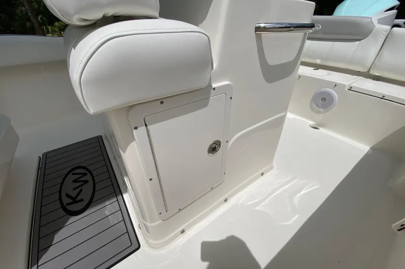 Slide: The Image of 2023 Key West 239 FS boat interior with white seating and storage compartment. - 73