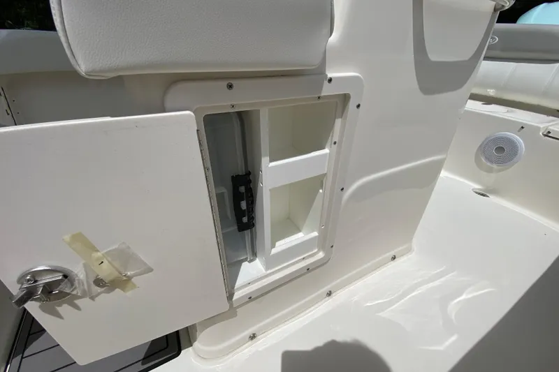 Slide: The Image of 2023 Key West 239 FS boat storage compartment with open door and speaker. - 74
