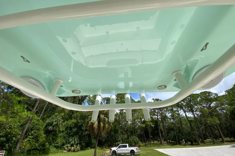 Slide: The Image of 2023 Key West 239 FS boat underside view with rod holders and speakers. - 78