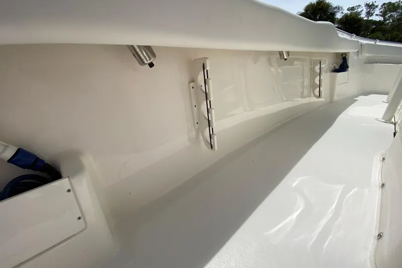 Slide: The Image of 2023 Key West 239 FS boat interior, showcasing sleek white design and storage features. - 79