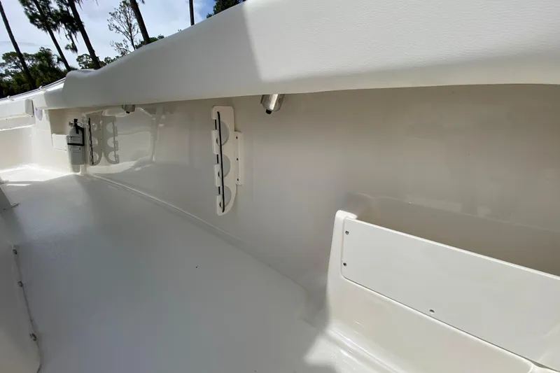 Slide: The Image of 2023 Key West 239 FS boat interior, featuring rod holders and storage compartments. - 80