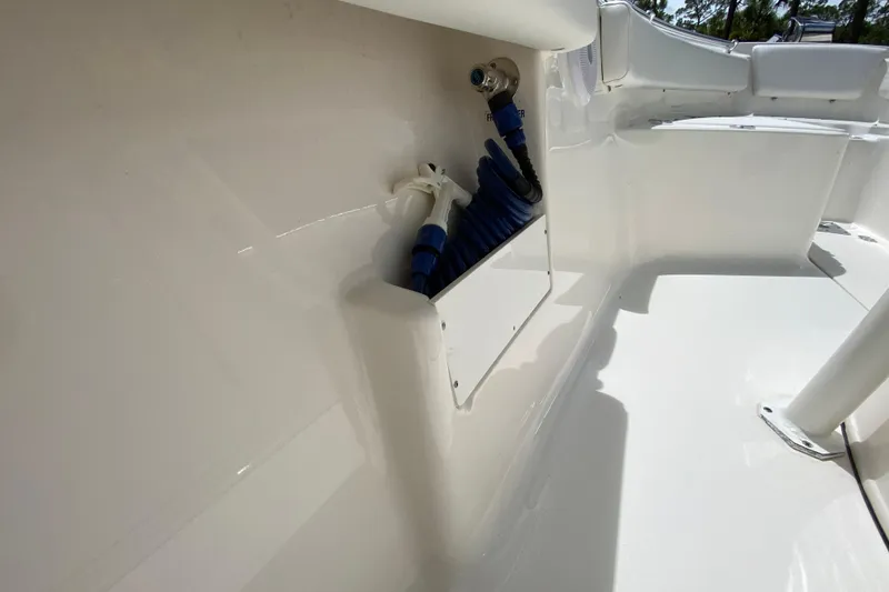 Slide: The Image of 2023 Key West 239 FS boat deck with coiled hose and clean white surface. - 81