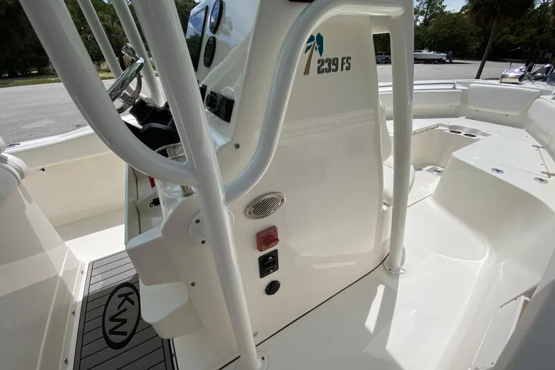 Slide: The Image of 2023 Key West 239 FS boat interior with steering console and seating area. - 83