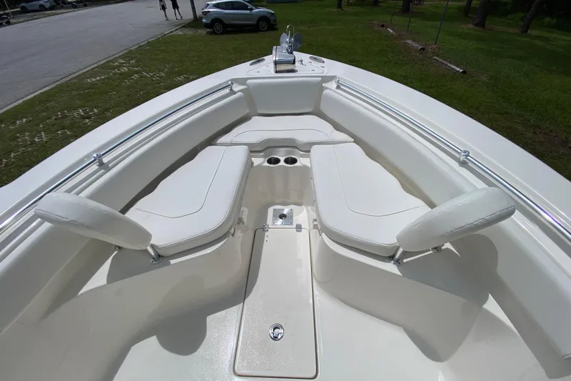 Slide: The Image of 2023 Key West 239 FS boat interior with white seating and cup holders. - 88