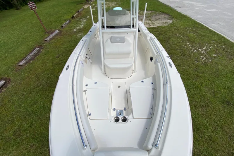 Slide: The Image of 2023 Key West 239 FS boat, white interior, spacious seating, parked on grass. - 89