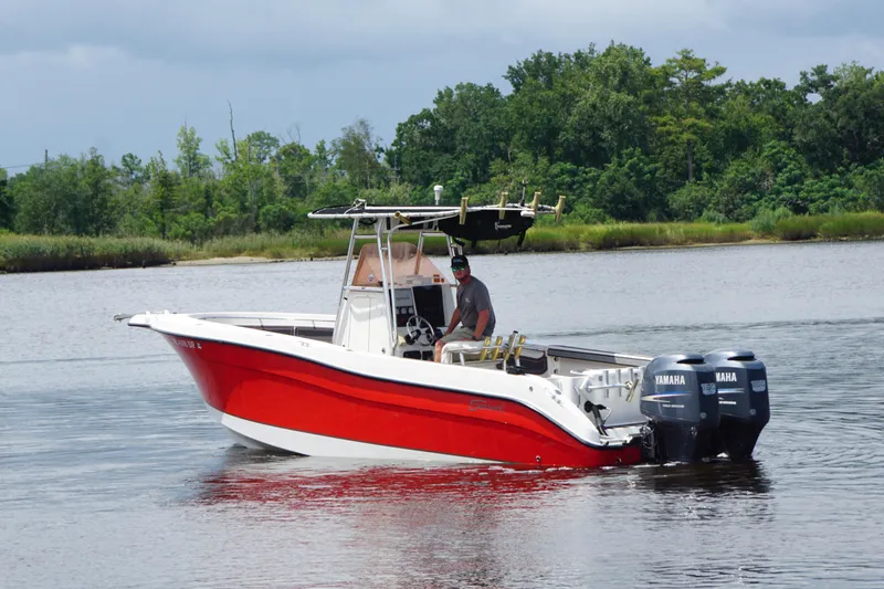The Image of 2006 Seaswirl Striper 2601 boat with dual Yamaha engines on a calm river. - 1