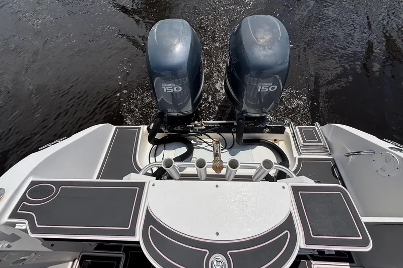 Slide: The Image of 2006 Seaswirl Striper 2601 boat with dual Yamaha 150 engines on water. - 11