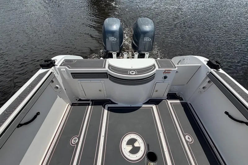 Slide: The Image of 2006 Seaswirl Striper 2601 boat deck with twin 150 horsepower engines on water. - 12