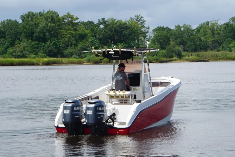Slide: The Image of 2006 Seaswirl Striper 2601 boat with dual Yamaha engines on a calm river. - 4